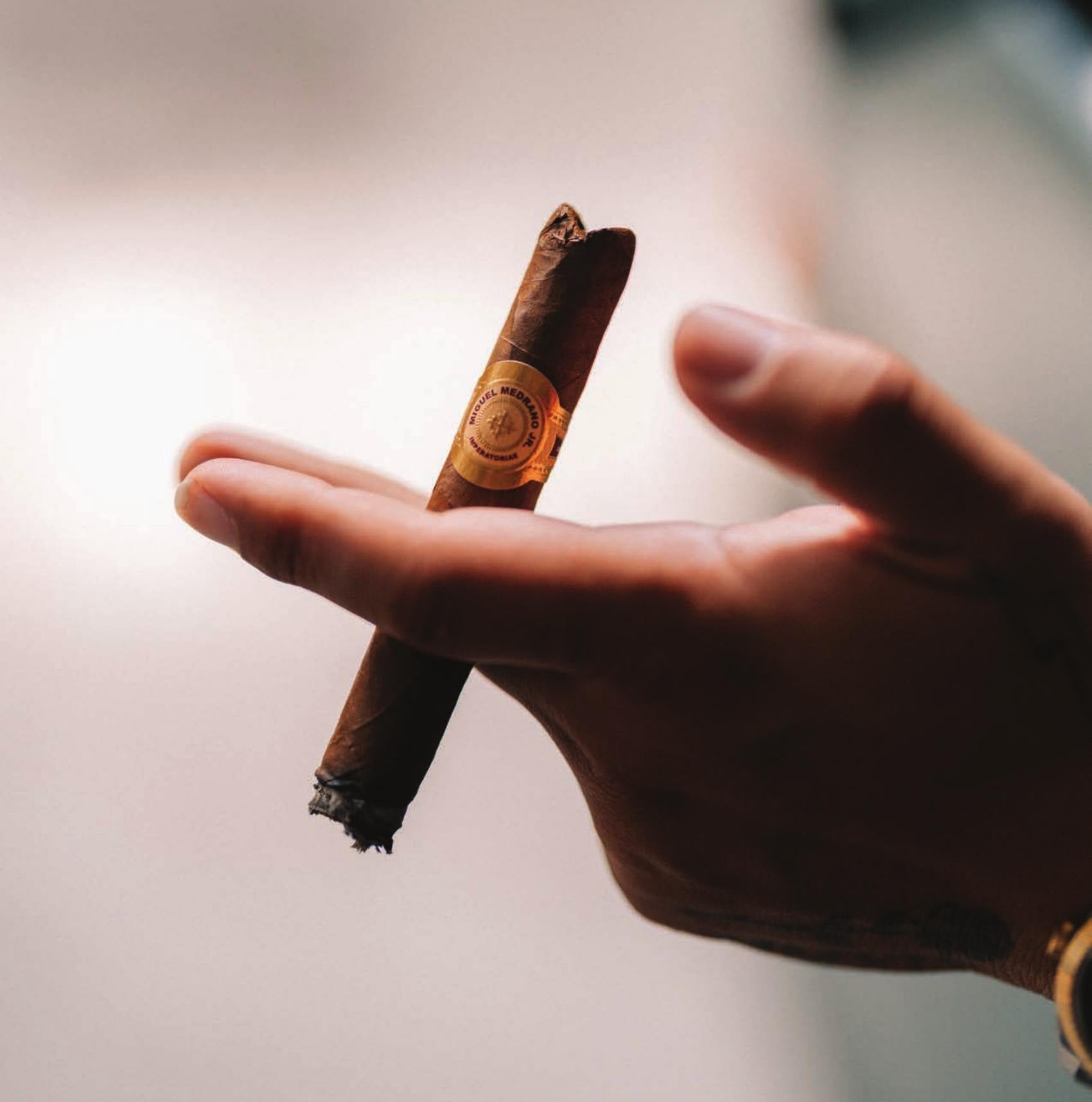 Tobacco Tactical cigar held in hand